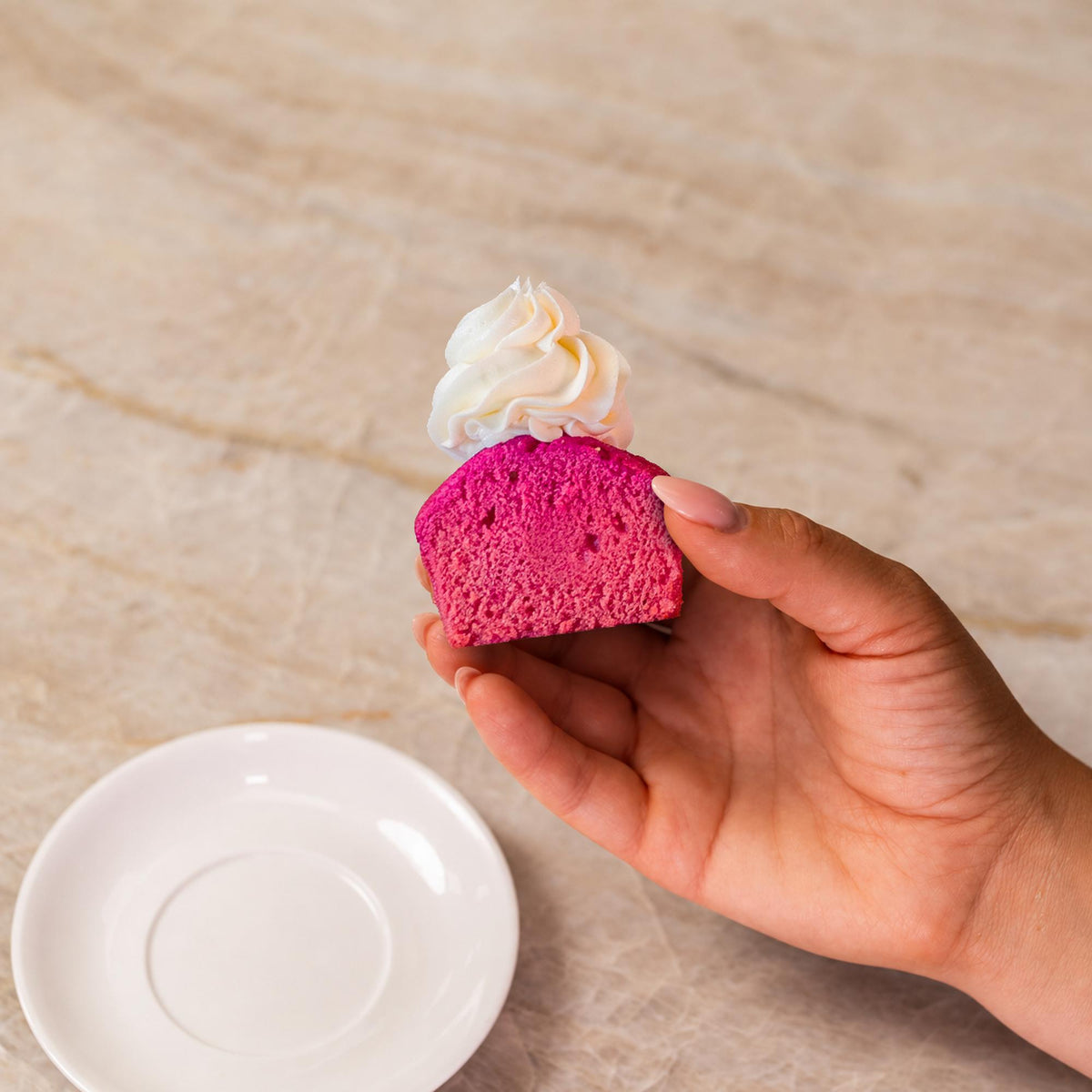 Pink cupcake made with natural food coloring powder.
