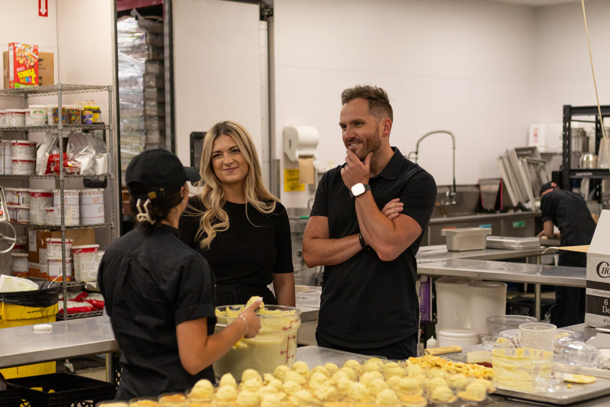 Bakery team discussing ADAMA natural food coloring during professional kitchen testing and development.
