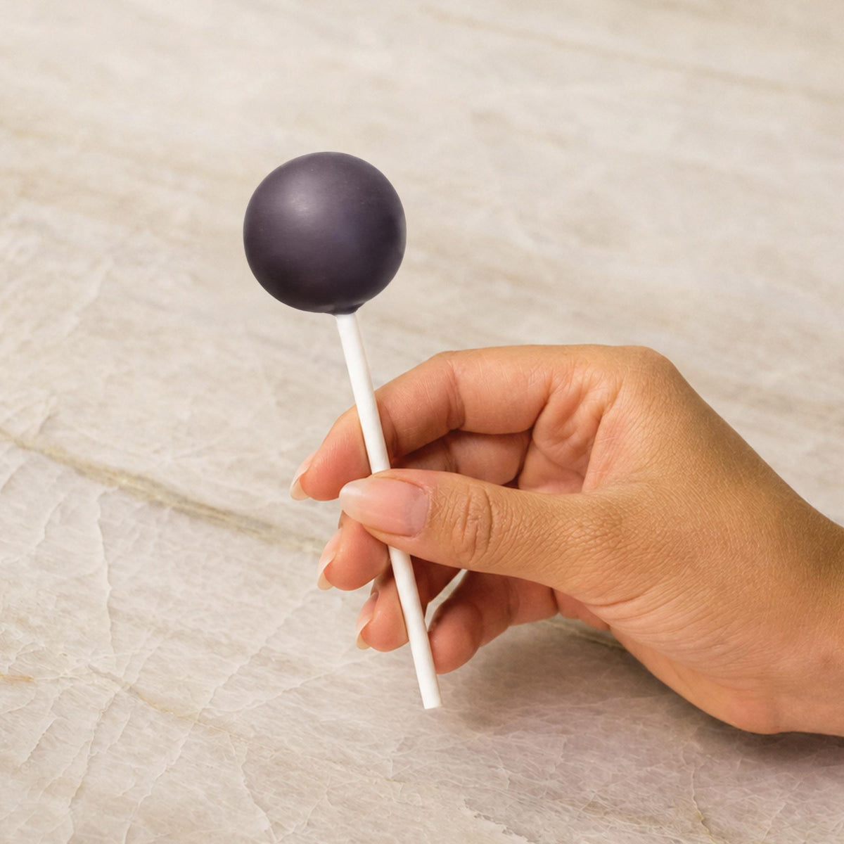 Black chocolate-coated cake pop made with natural food coloring powder.