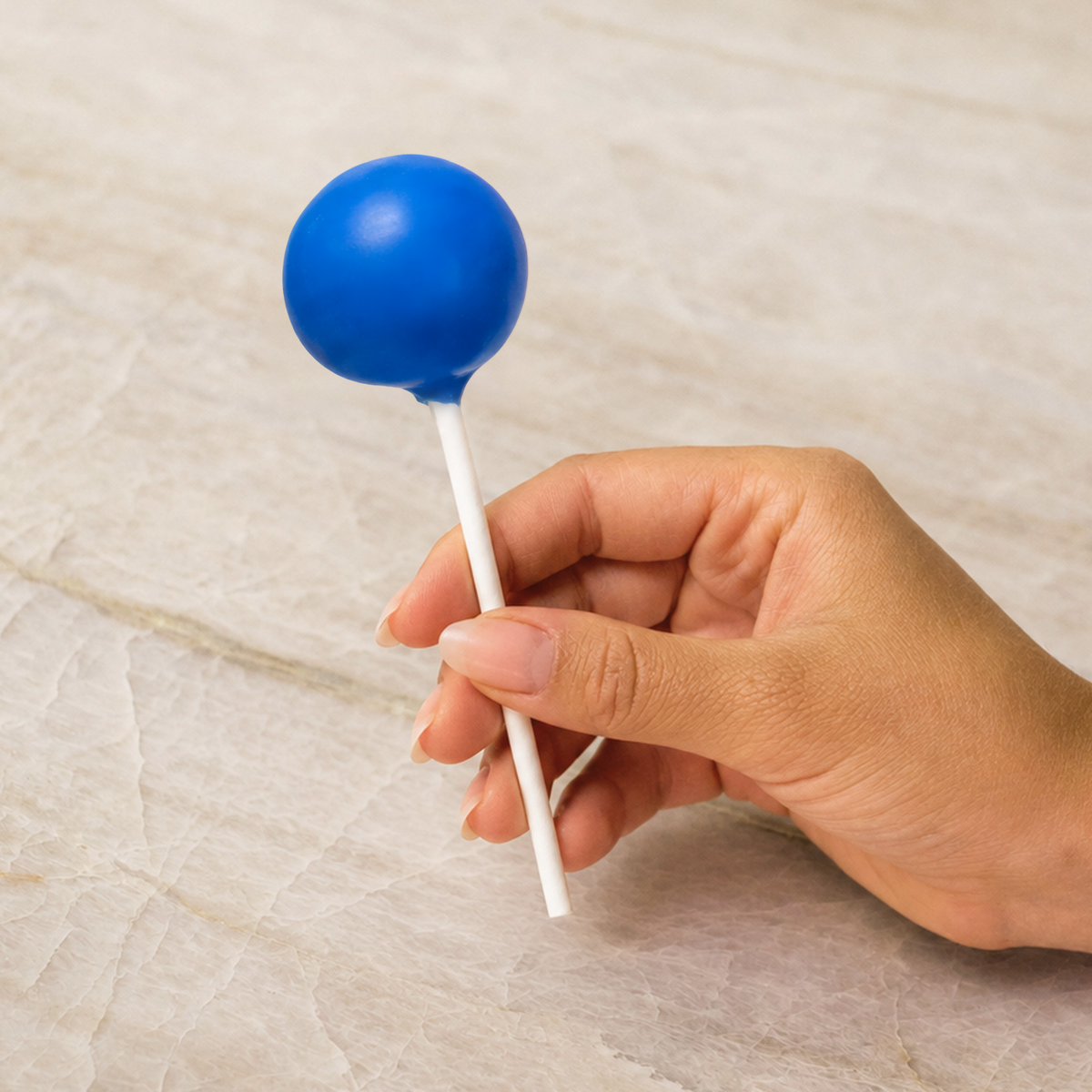 Blue chocolate-coated cake pop made with natural food coloring powder.