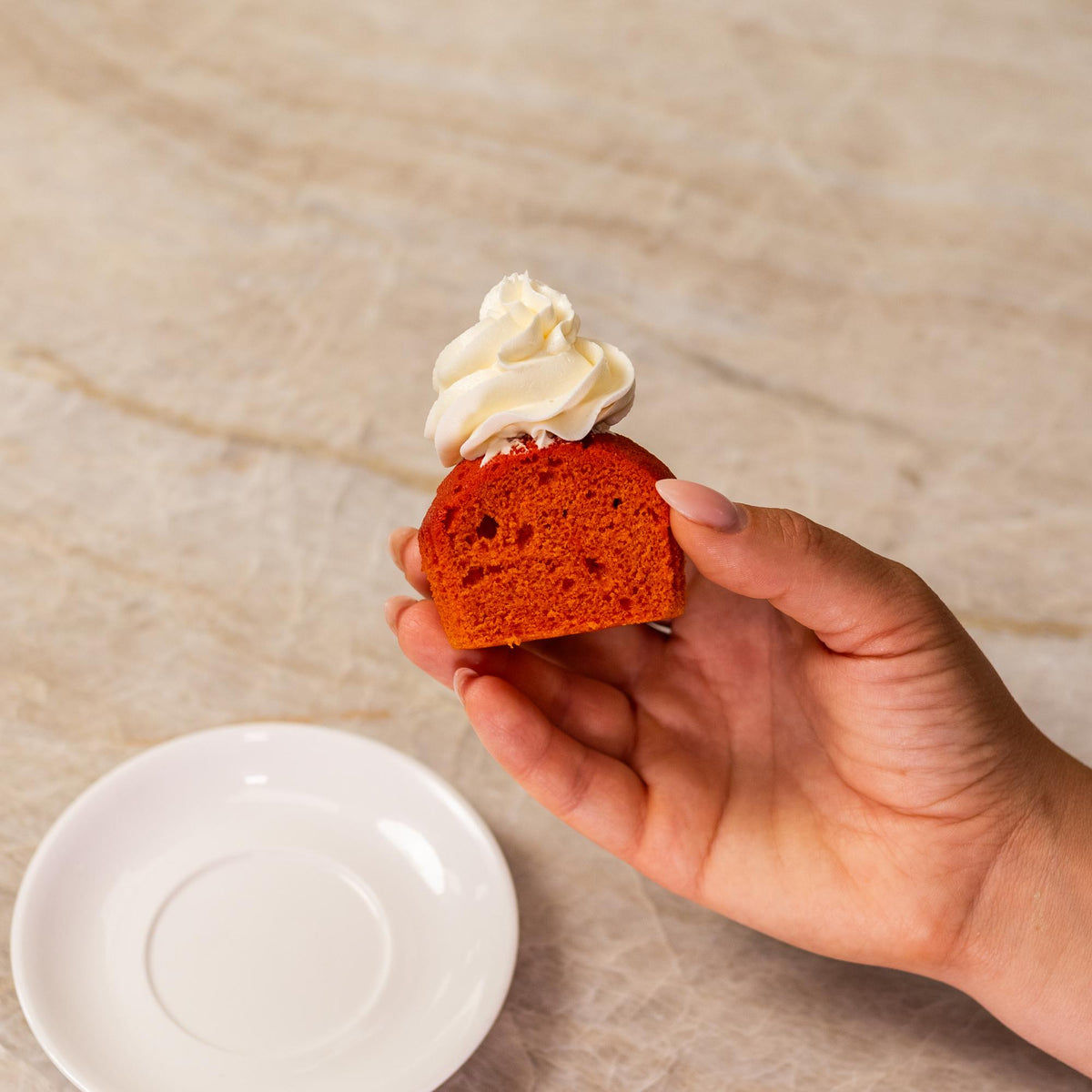 Orange cupcake made with natural food coloring powder.