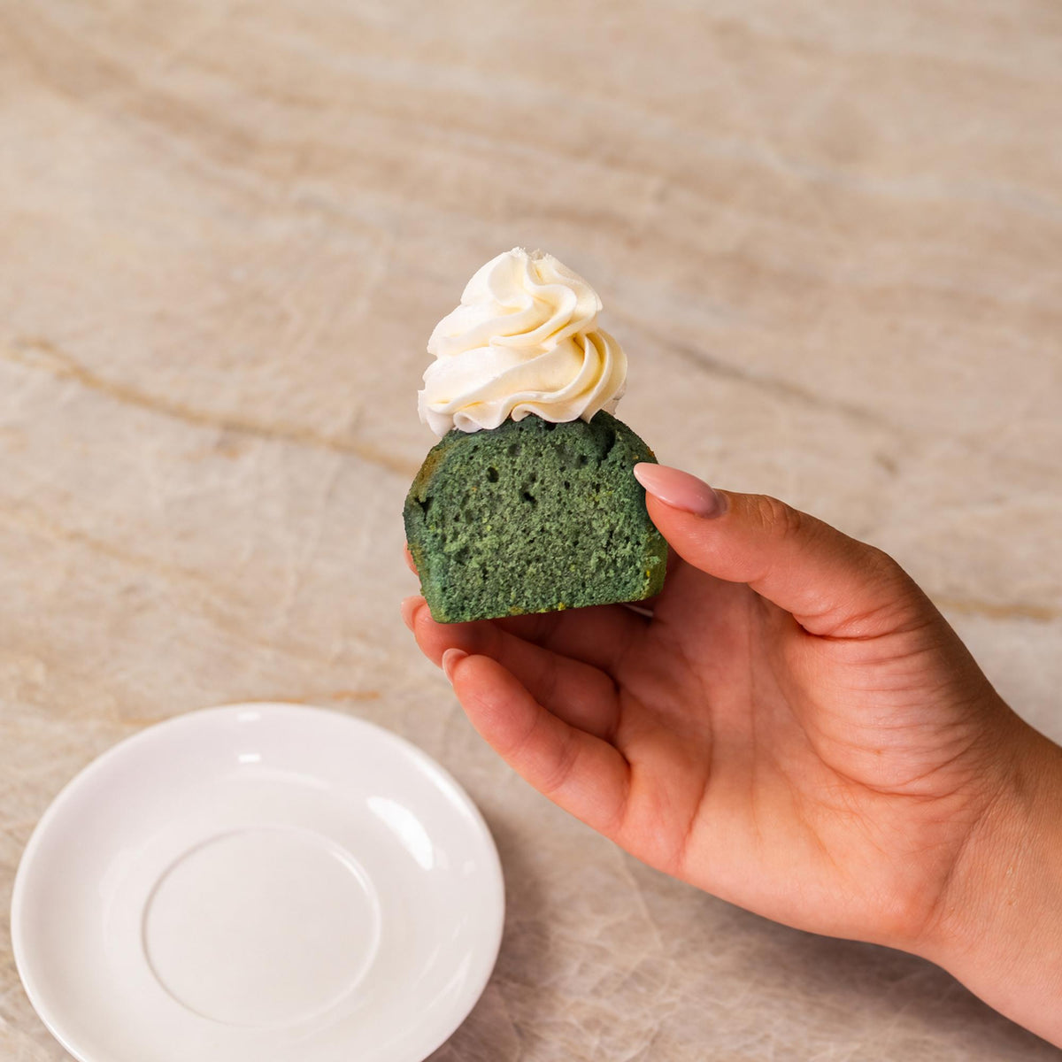 Teal cupcake made with natural food coloring powder.