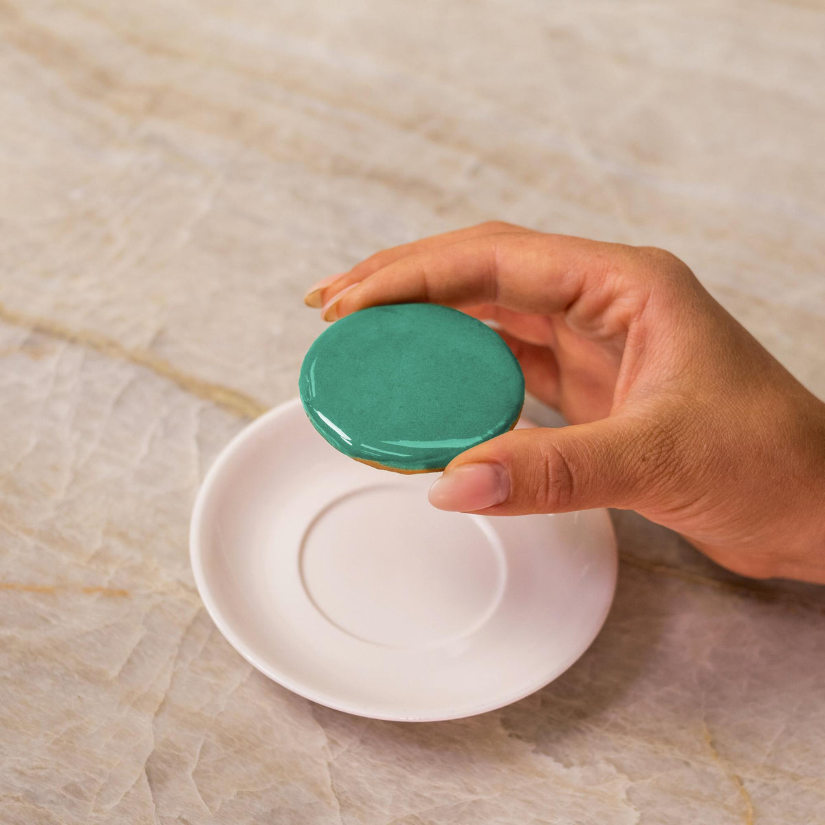 Teal icing on cookie made with natural food coloring powder.