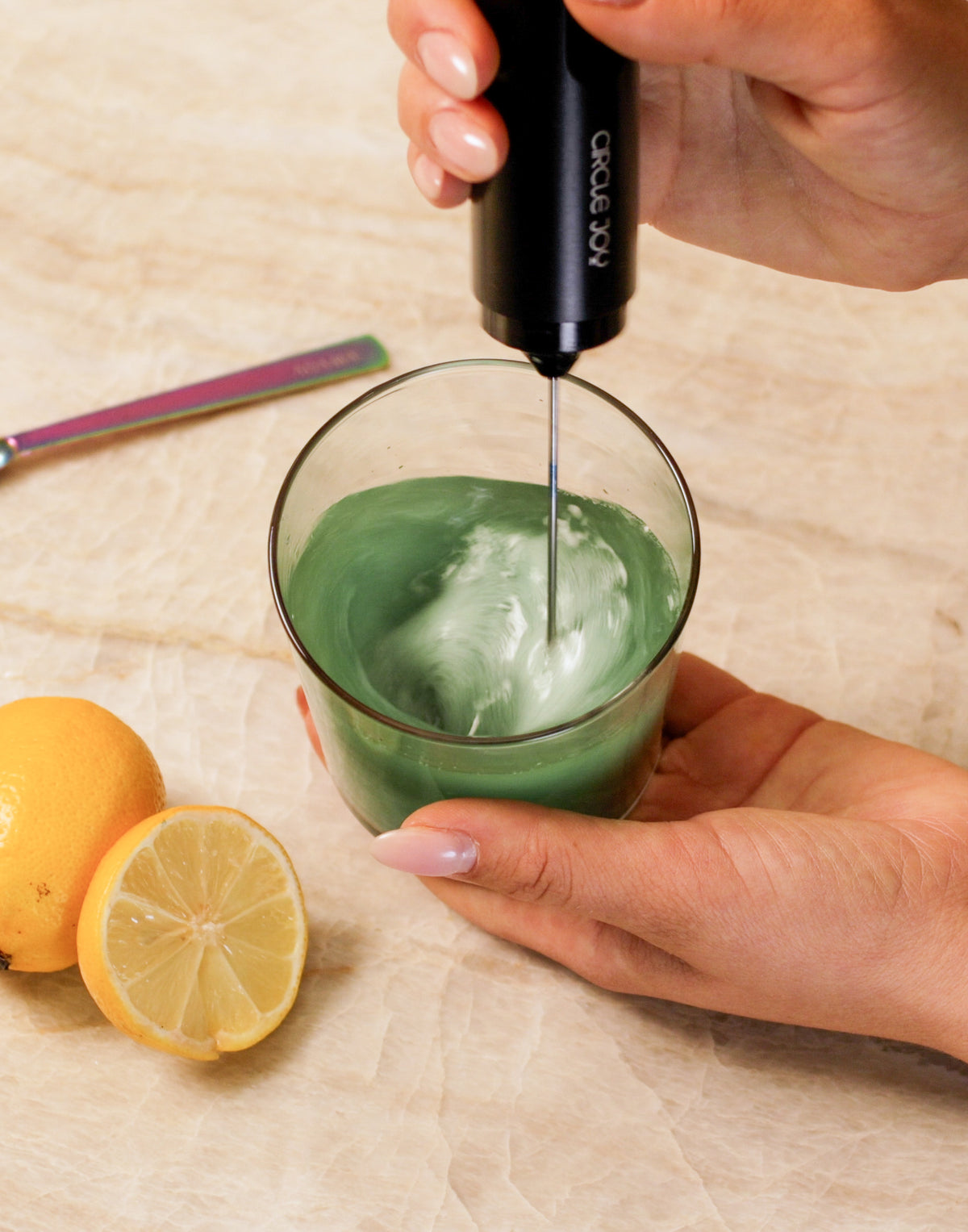 Green drink being mixed with ADAMA natural food coloring powder.