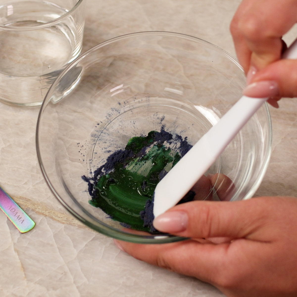 ADAMA natural food coloring powder being mixed into frosting.