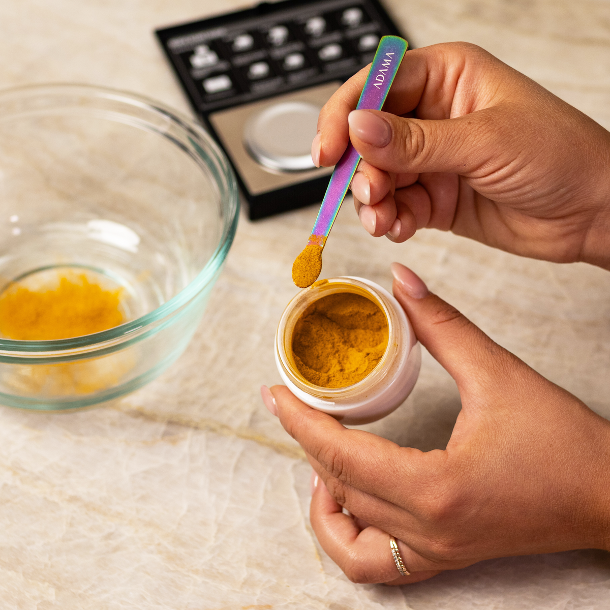 Orange ADAMA natural food coloring powder being measured into cake batter.