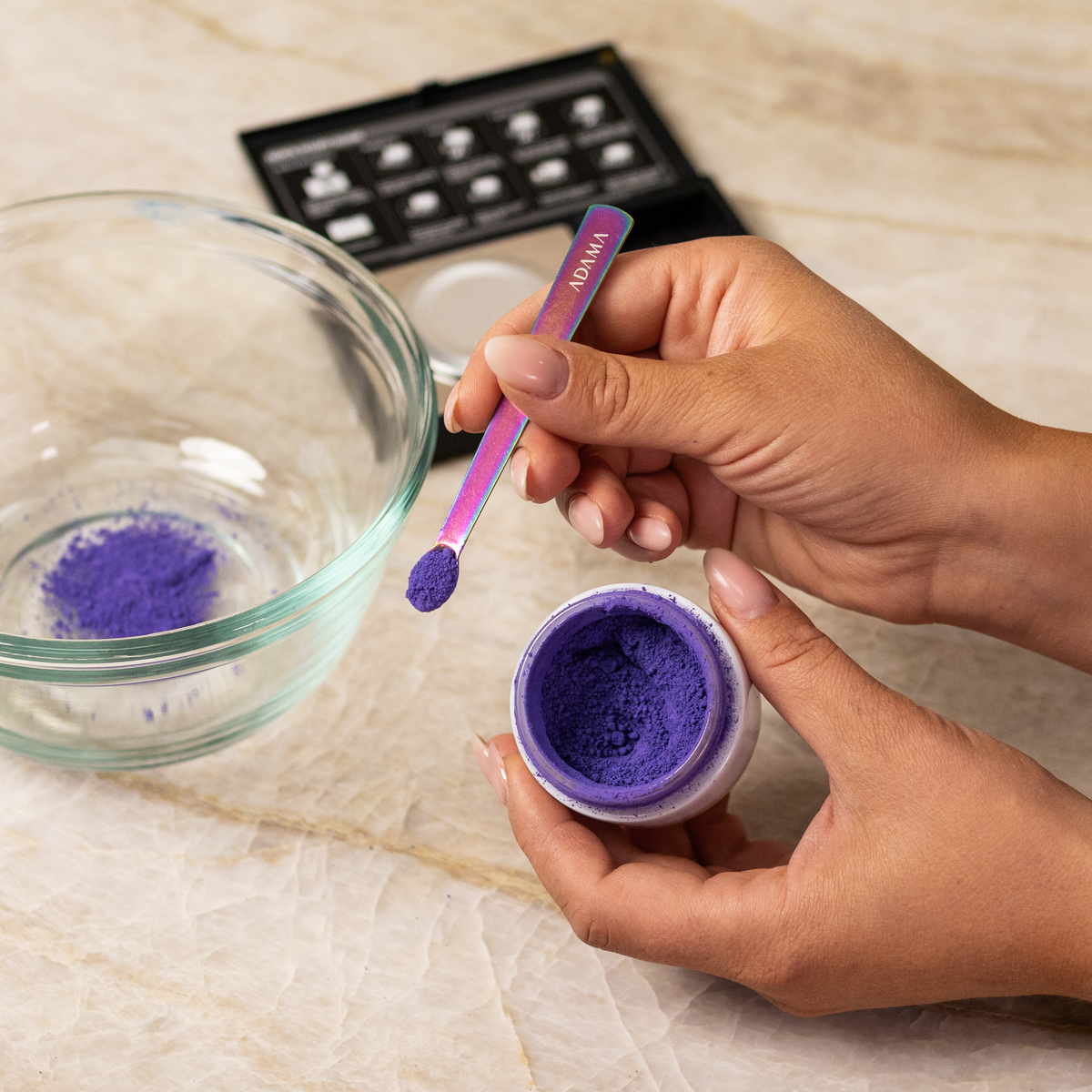 Purple ADAMA natural food coloring powder being measured into chocolate.
